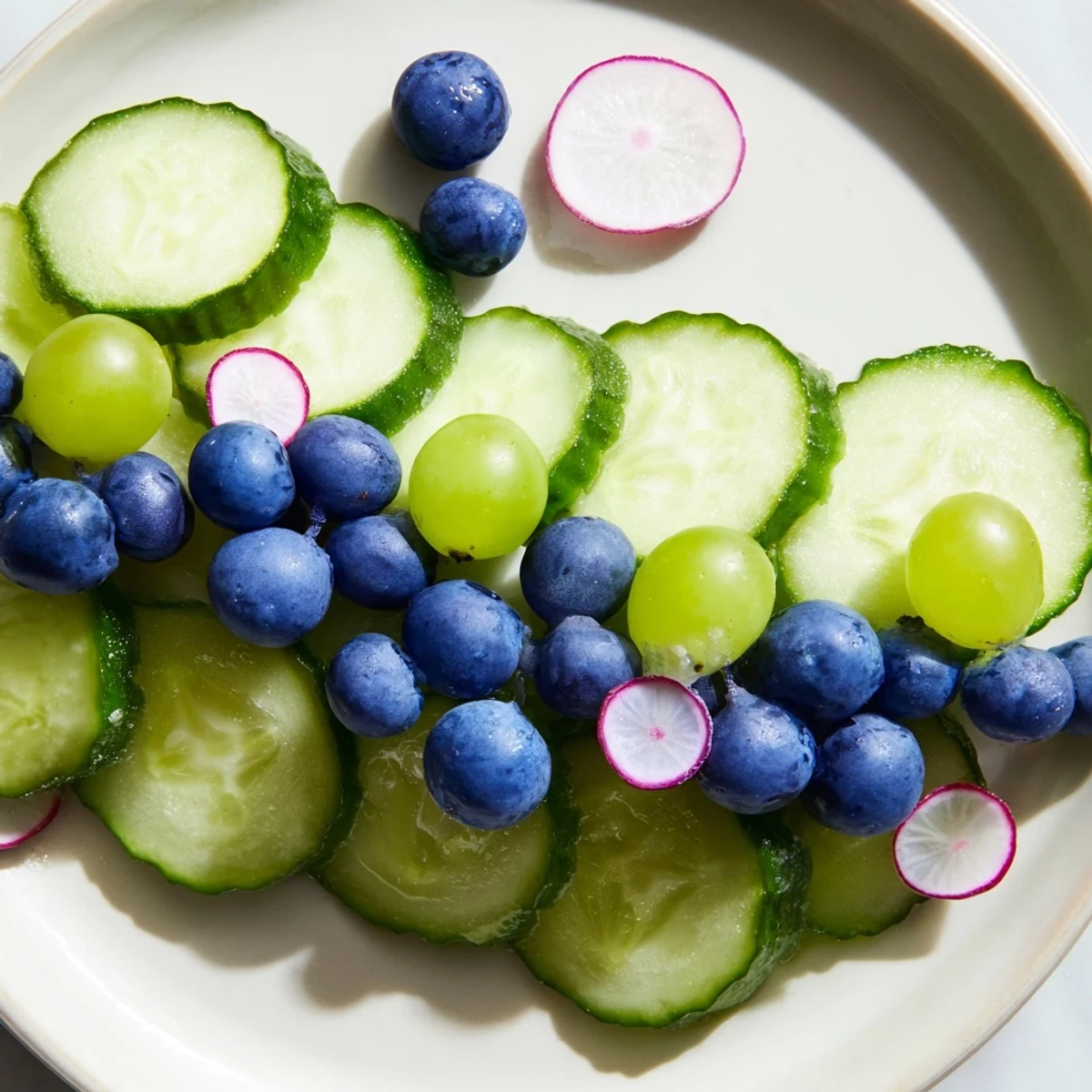 Crisp cucumber slices and blue grapes make an elegant Peacock Tail appetizer, ready to serve immediately.