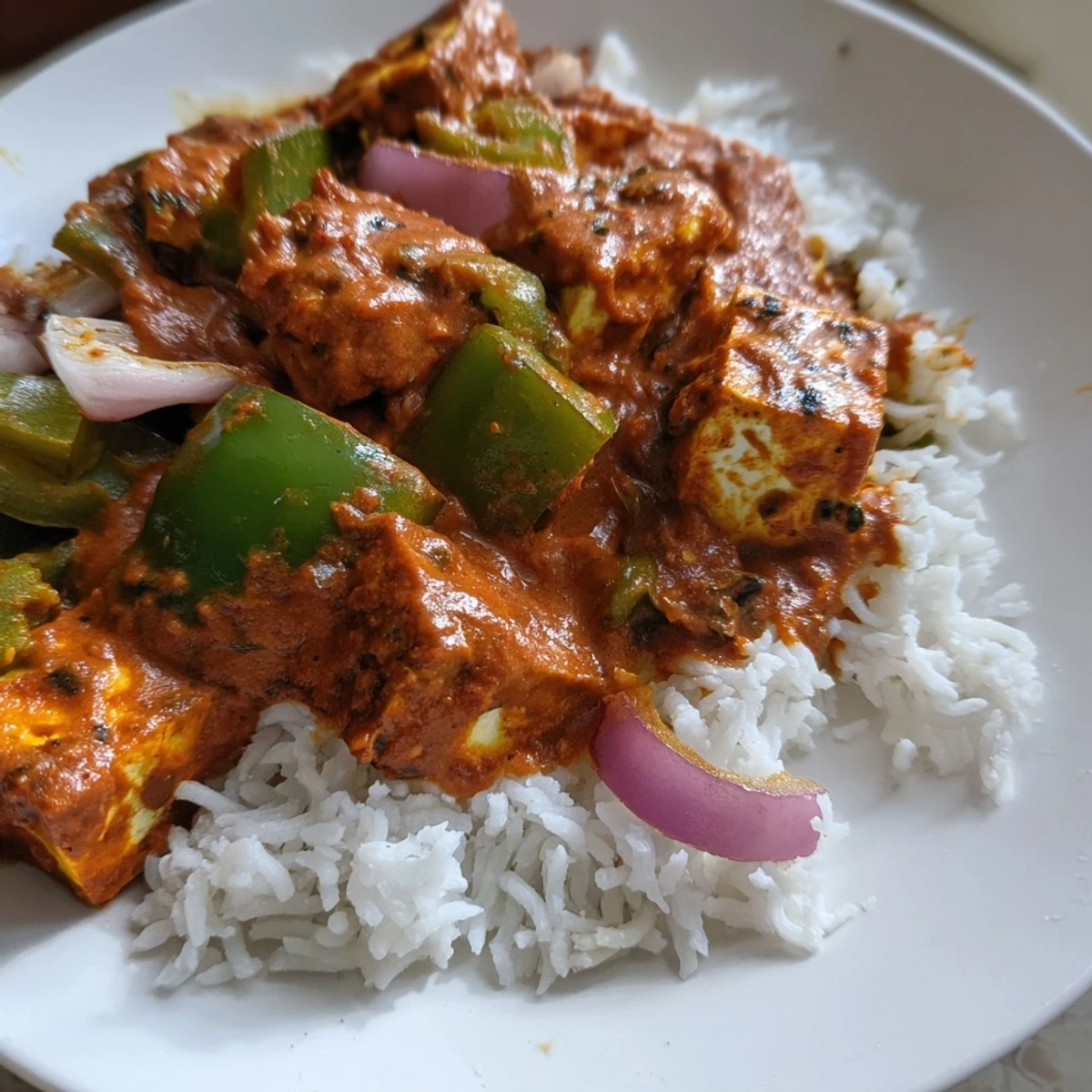 Creamy, vibrant Paneer Tikka Masala, a delicious vegetarian Indian meal, garnished with cilantro.