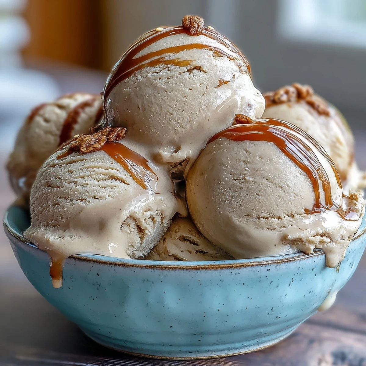 Rich, brown Hojicha Ice Cream in a ceramic bowl, topped with toasted sesame seeds and ready to serve.