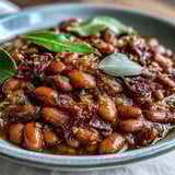 Pinto beans with diced onion and minced garlic, served warm as a hearty taco filling.