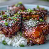 Honey Garlic Chicken with Rice in a slow cooker, served over fluffy jasmine rice with sesame seeds and green onions.
