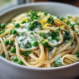 A creamy bowl of Spring Pasta: Ricotta and Lemon Linguine with Peas, bright with lemon zest and fresh herbs.