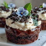 Whimsical Mother's Day Flower Pot Brownies with Oreo Dirt topped with flowers.