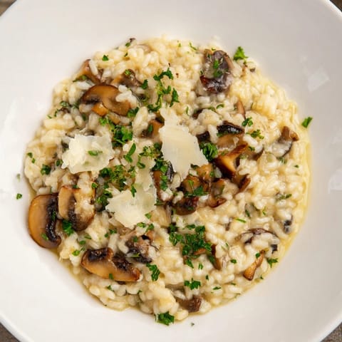 Stove-Top Creamy Risotto: A steaming bowl of creamy risotto with visible Parmesan cheese and fresh parsley.