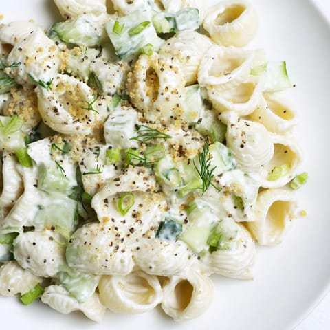 Creamy Cucumber Crunch Pasta Salad with tender shells, crisp cucumbers, and fresh dill, topped with everything bagel seasoning.  