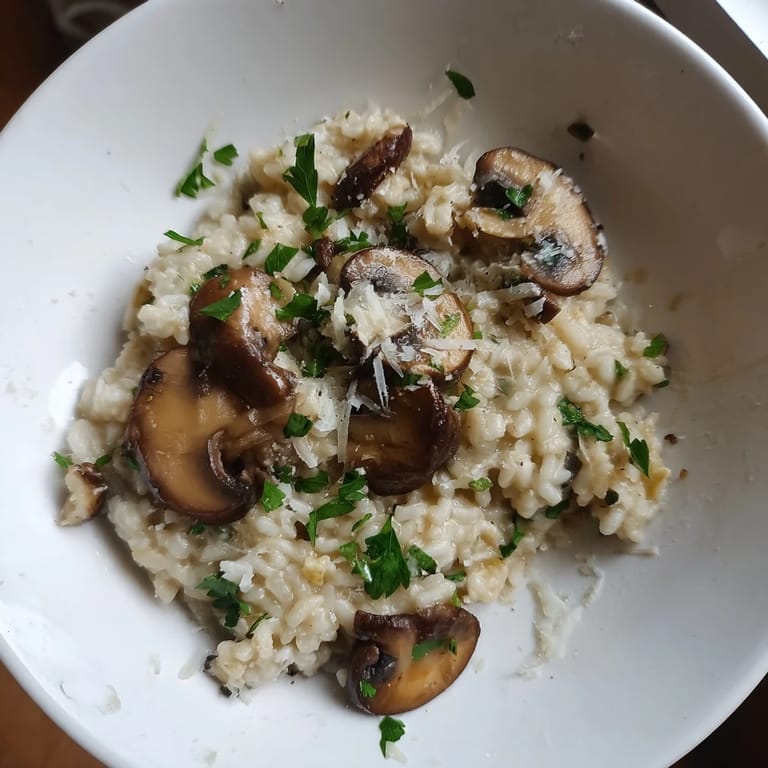 Spoonful of rich and flavorful Stove-Top Creamy Risotto, a comforting Italian meal, with mushroom and cheese.