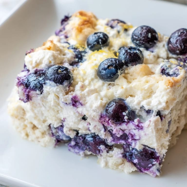 A close-up of a Blueberry Cottage Cheese Bake, highlighting the textures of creamy cottage cheese.