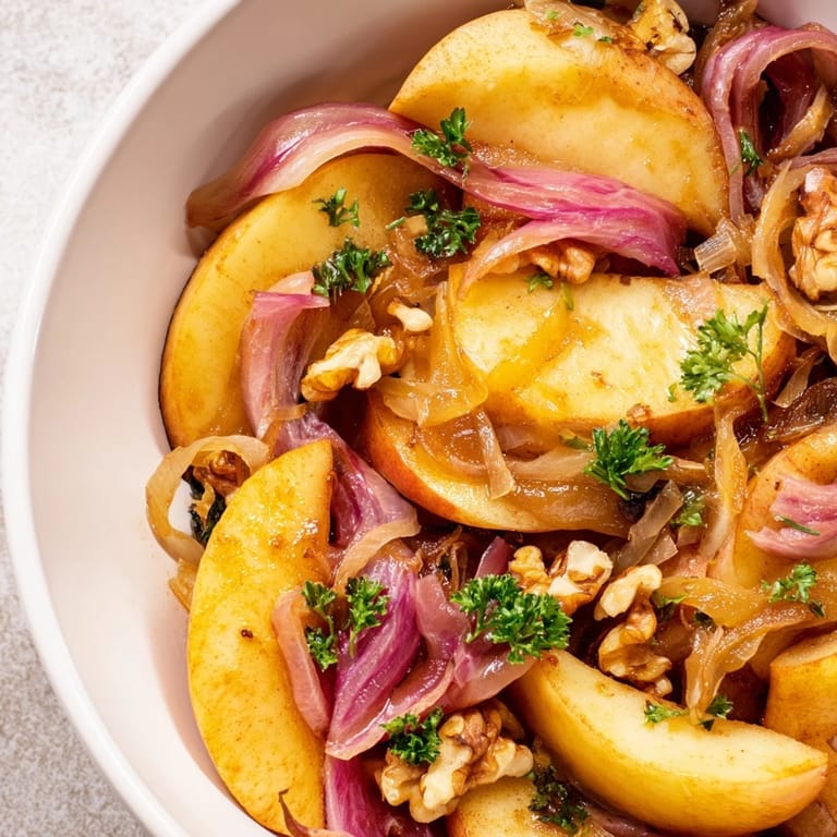 A vibrant bowl of Warm Apple and Sauerkraut Skillet Salad garnished with fresh parsley.